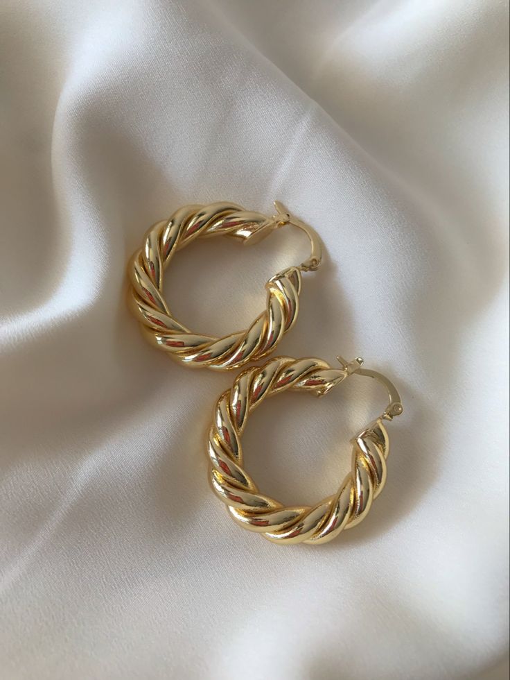 Earrings placed on a white silk cloth