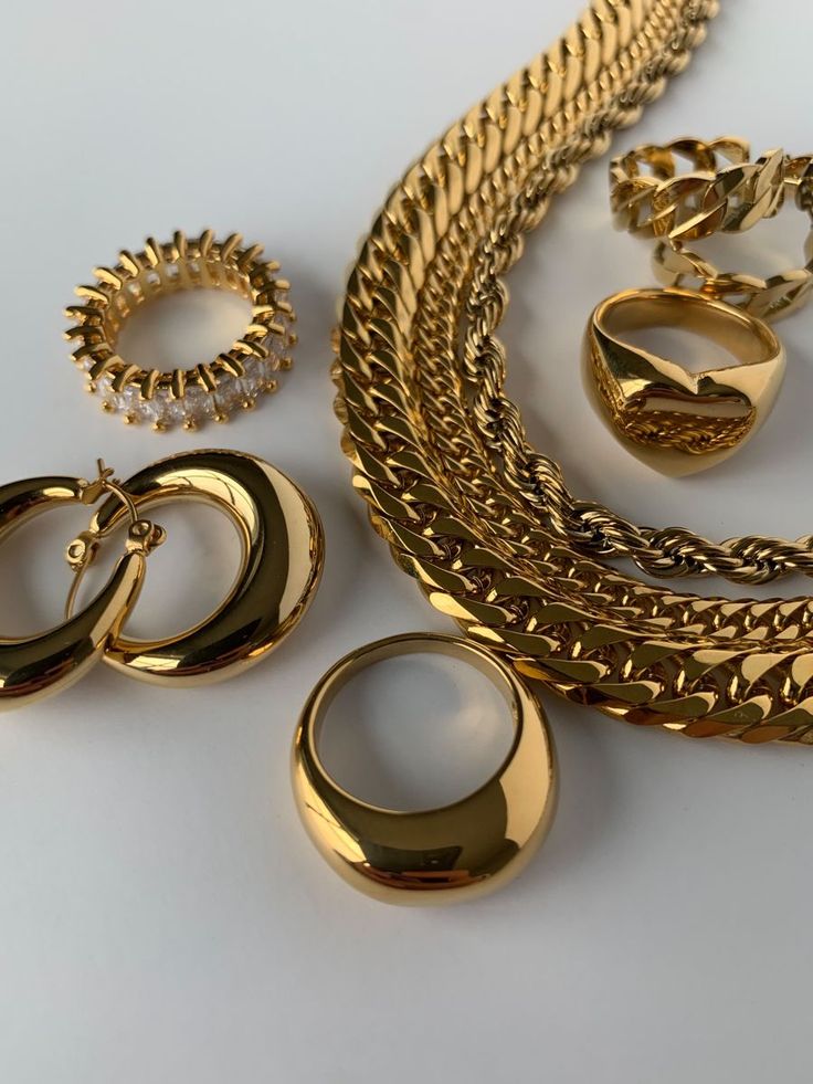 Gold rings, earrings and chain on a table